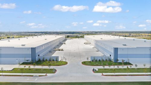 Large modern industrial warehouses under blue sky