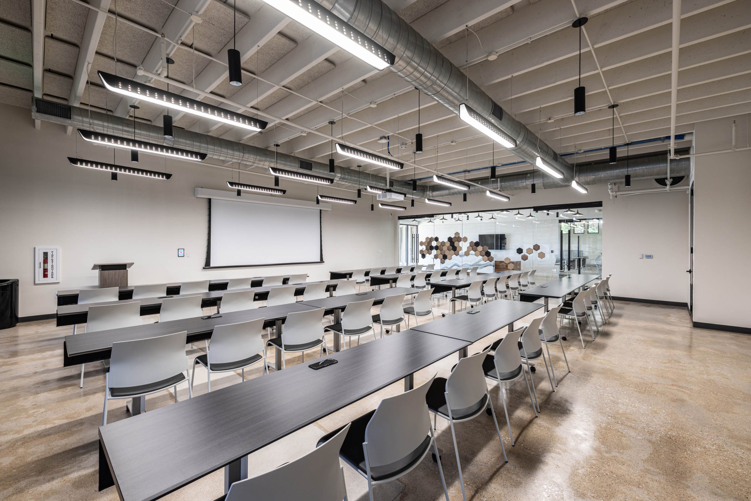 Modern classroom with rows of tables and chairs