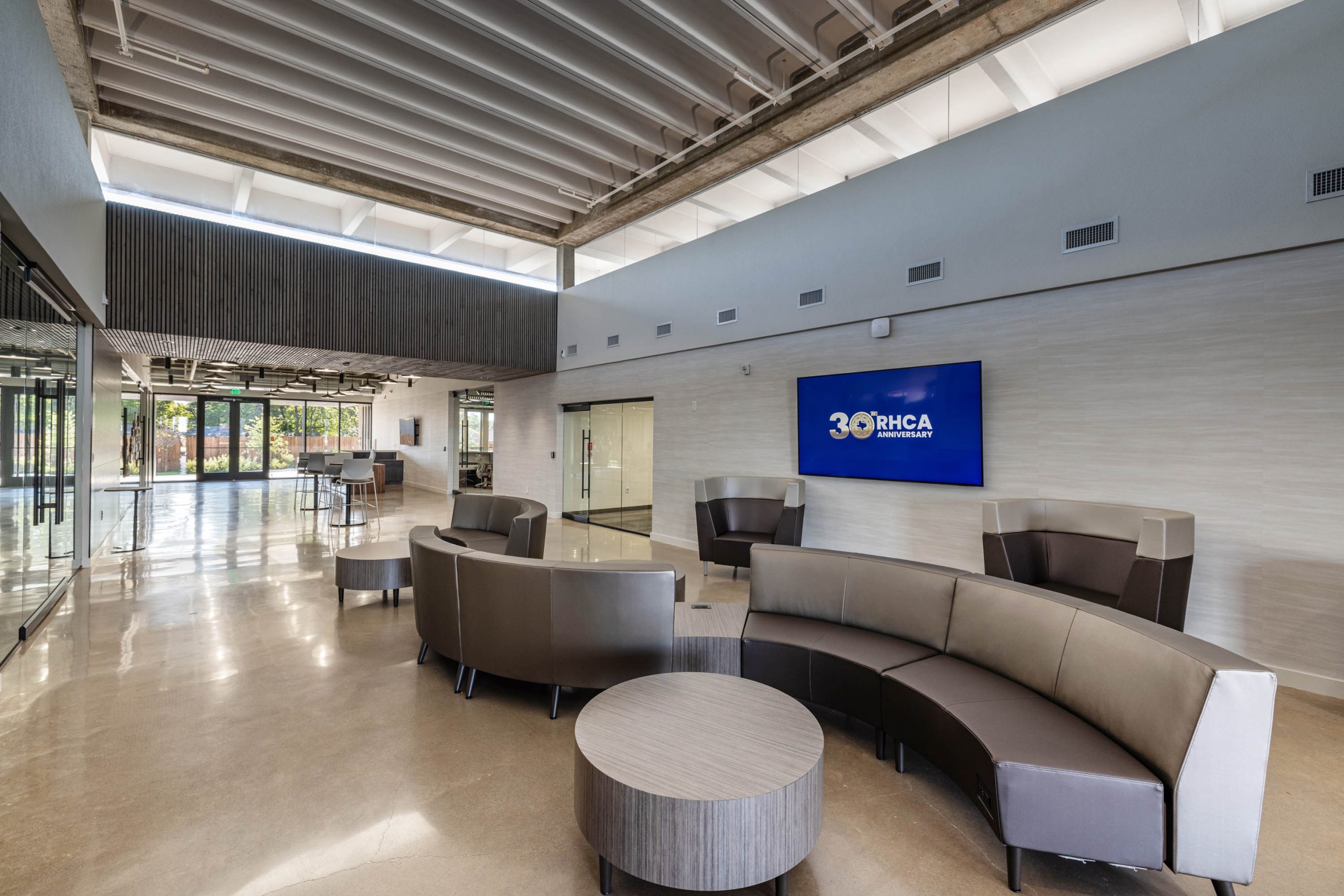 Modern lobby with curved seating and screen