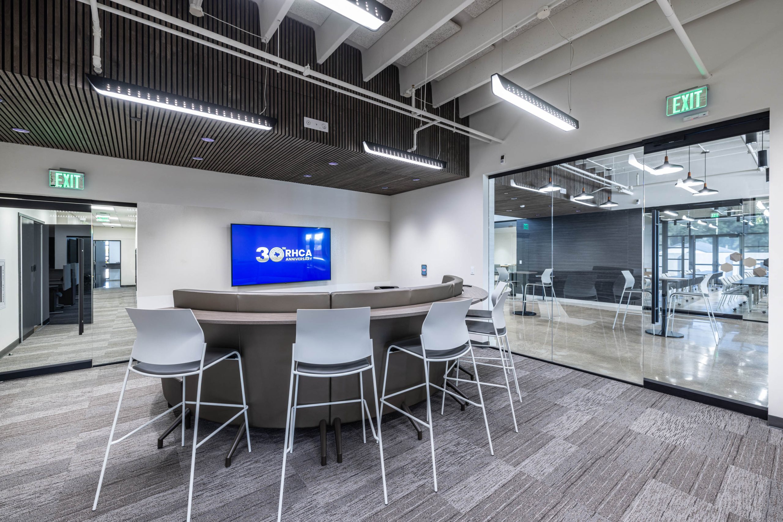 Modern office lounge with screen and chairs