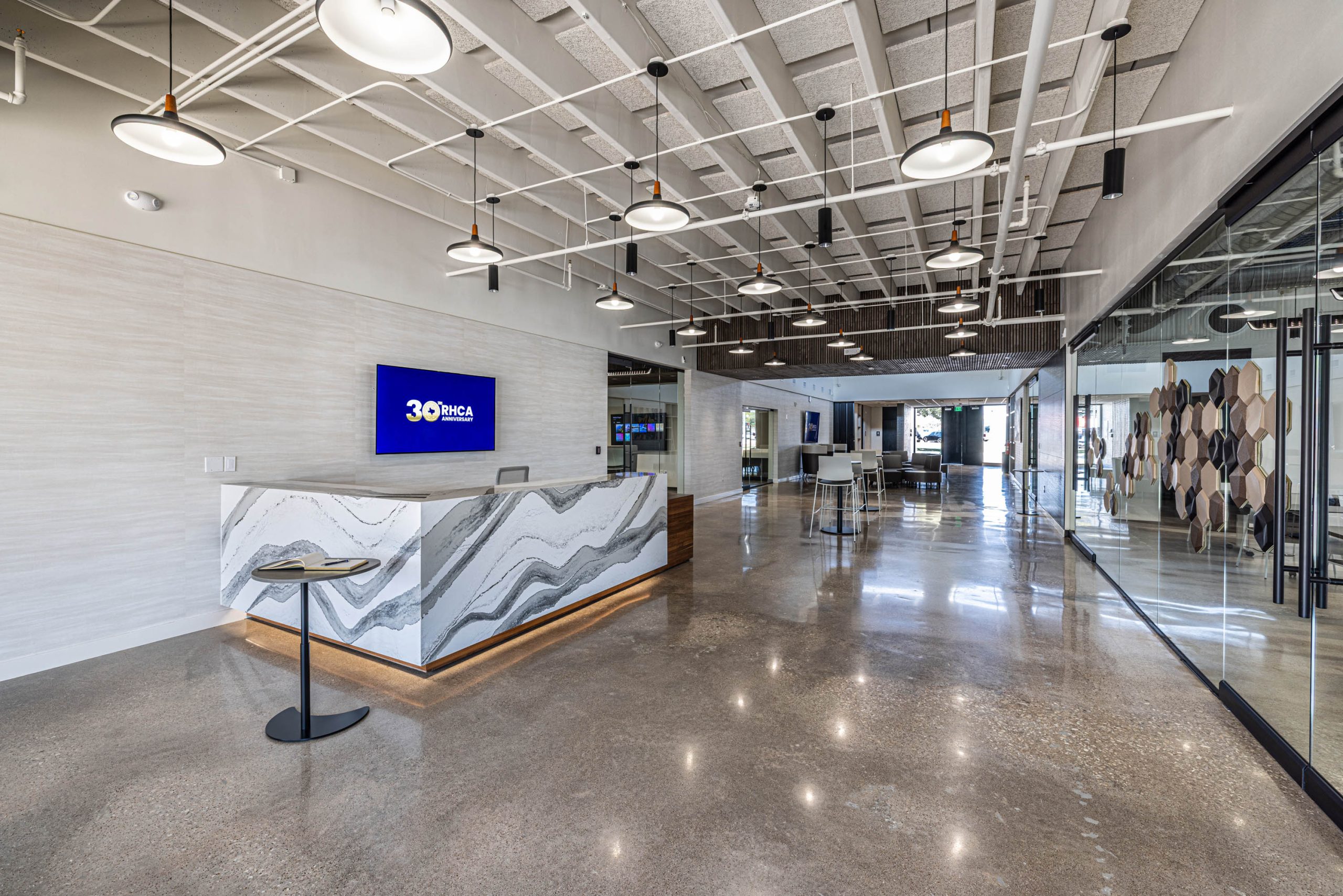 Modern office lobby with reception desk.