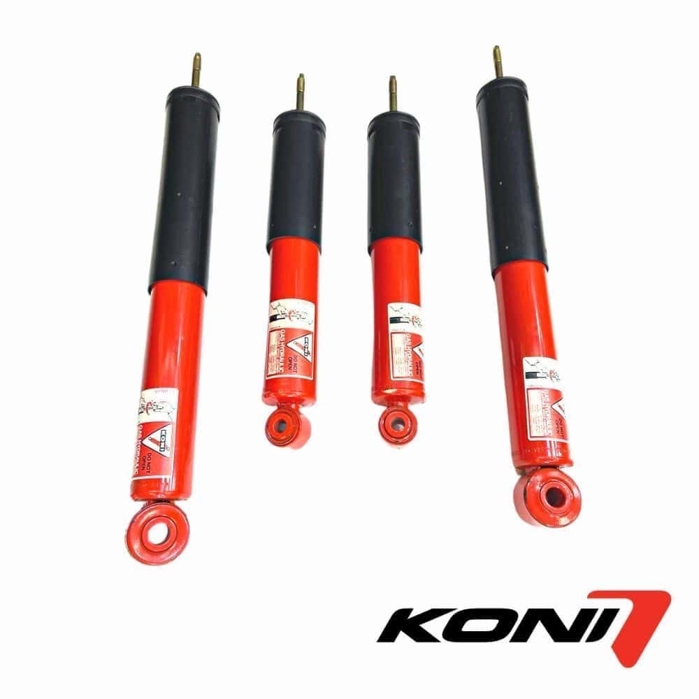 Shock absorbers for heavy machinery and vehicles, featuring durable red and black design.