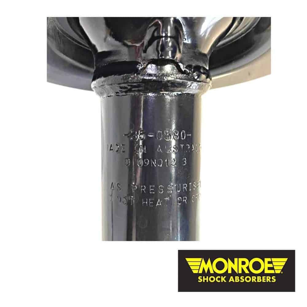 Industrial shock absorber component with Monroe Shock Absorbers logo.