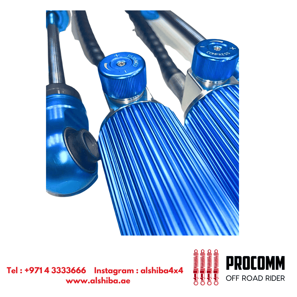 Blue off-road motorcycle shock absorbers with adjustable components and coil springs.