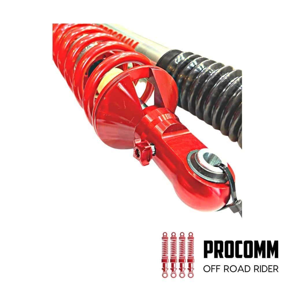 Red off-road suspension shock absorber for vehicles, with coil springs and mounting hardware.