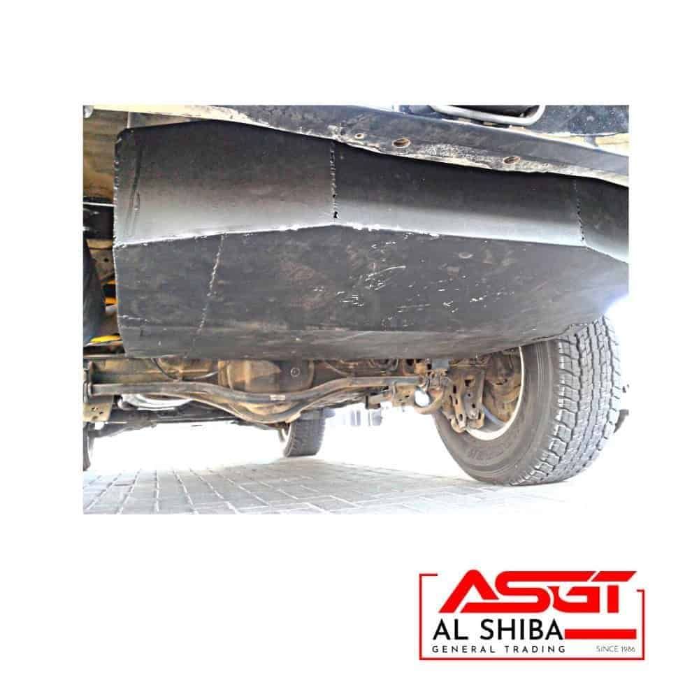 Underneath view of a vehicle showing the undercarriage and tire, with Al Shiba General Trading logo.