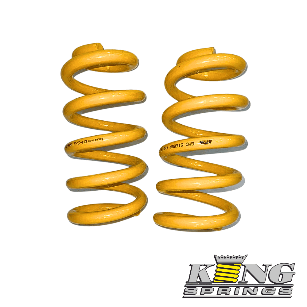Yellow coil springs for automotive suspension from Al Shiba General Trading.