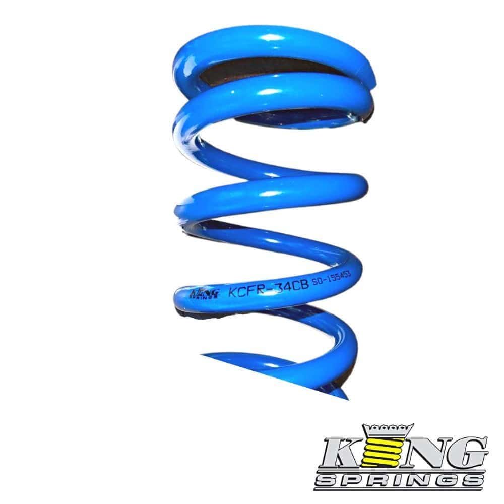 Blue coil spring for industrial or automotive use, isolated on white background.