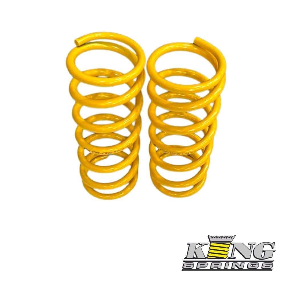 Yellow coil springs for industrial or automotive use, displayed against a white background.
