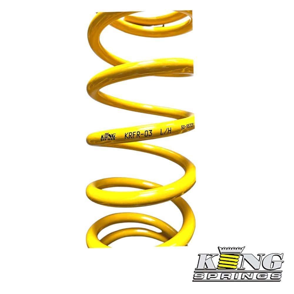 High-quality yellow coil spring for automotive suspension systems.
