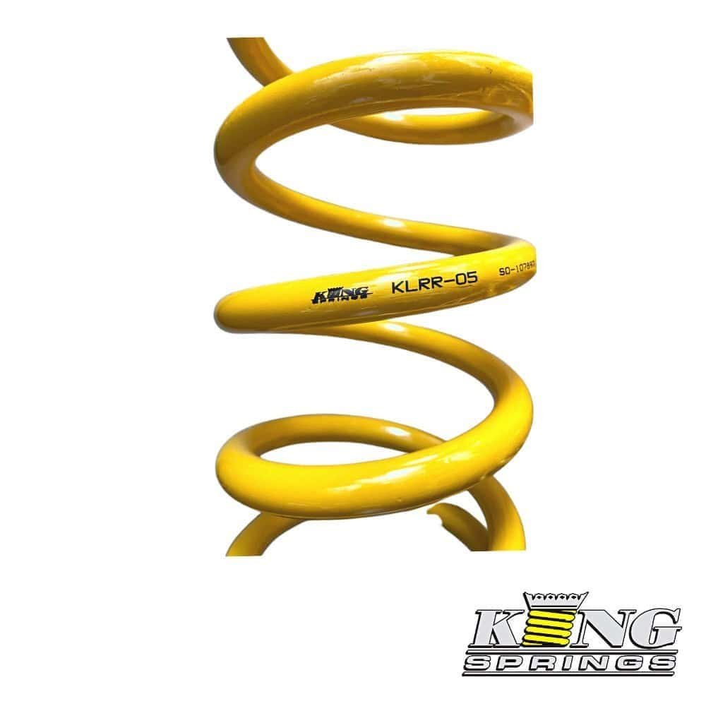 High-quality yellow coil spring for industrial or automotive use, showcasing durability and precisio.
