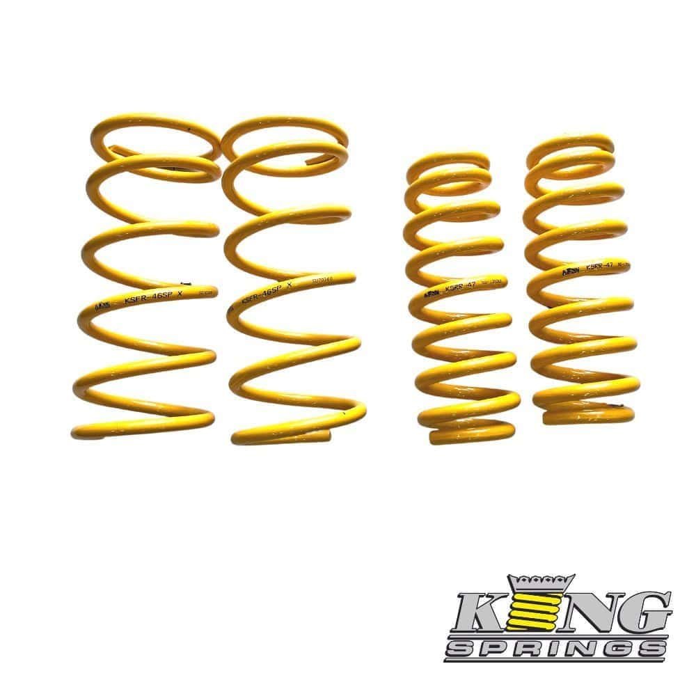 Yellow coil springs for automotive suspension, displayed in a row.