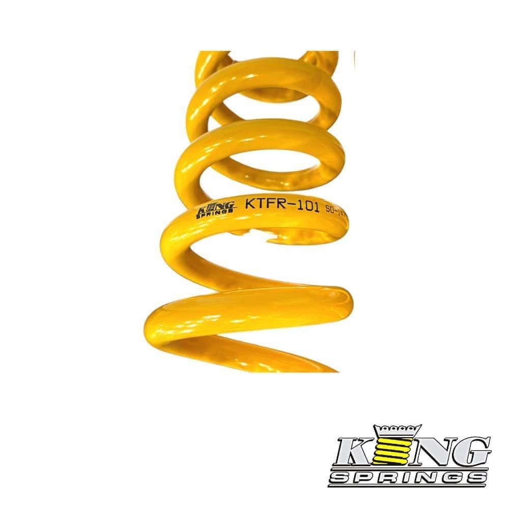 Heavy-duty yellow coil spring for industrial suspension systems.