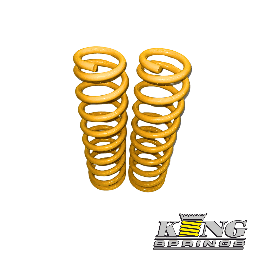 Yellow coil springs for industrial or automotive use, stacked vertically.