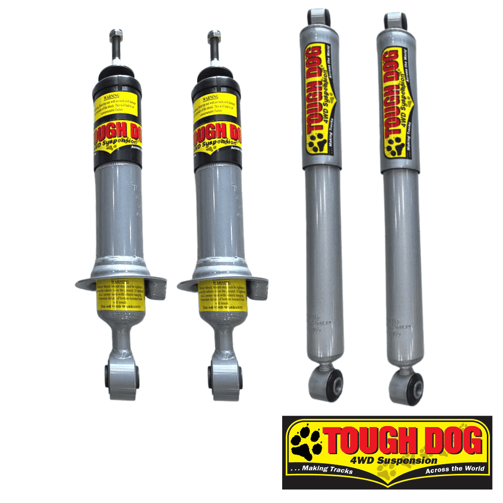 Heavy-duty shock absorbers for 4WD vehicles with Tough Dog branding and yellow warning labels.