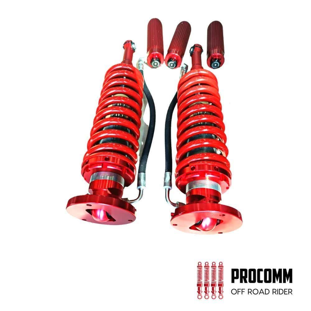 Red motorcycle shock absorbers with mounting hardware for off-road riding.