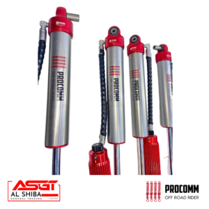 Four Procomm off-road rider shock absorbers with red tops and chrome bodies, displayed with branding logos at the bottom (Al Shiba and Procomm).