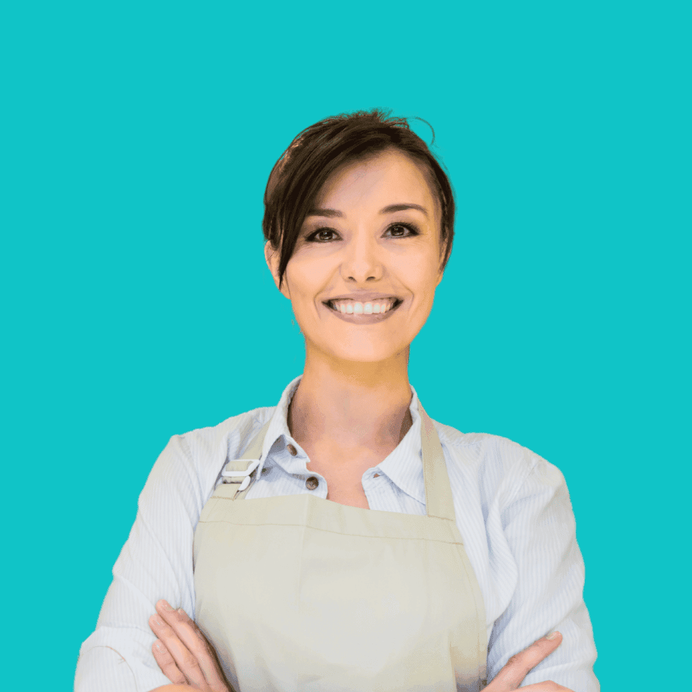 Smiling woman wearing an apron on a turquoise background.