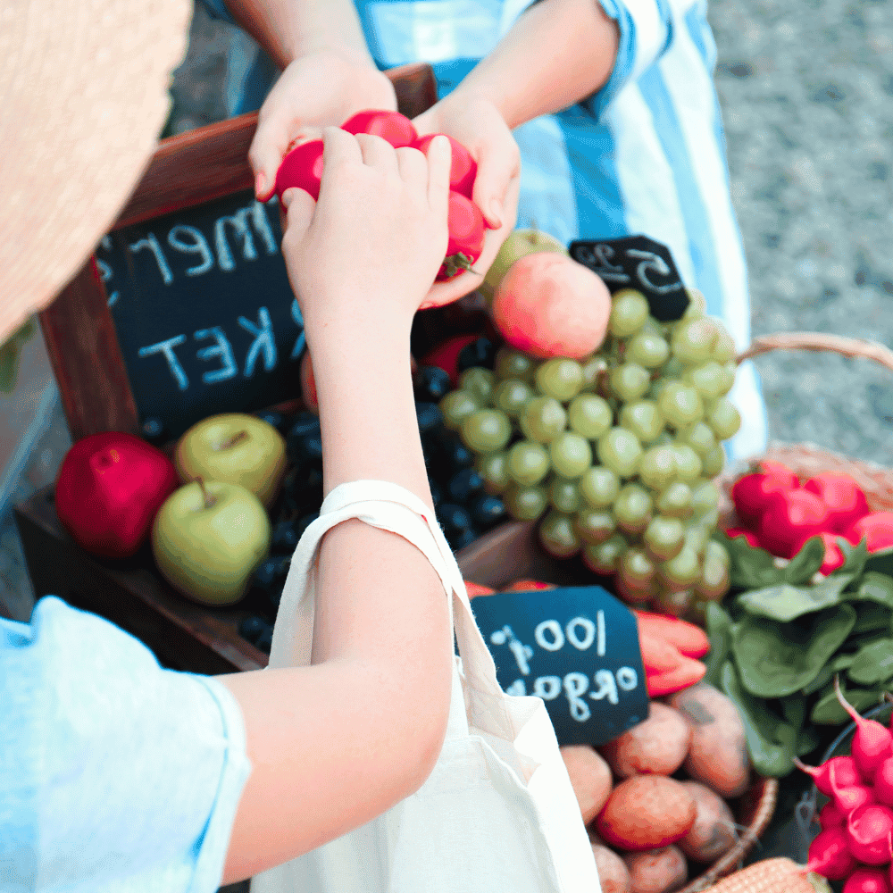 People buying fresh vegetables at the farmer's market.