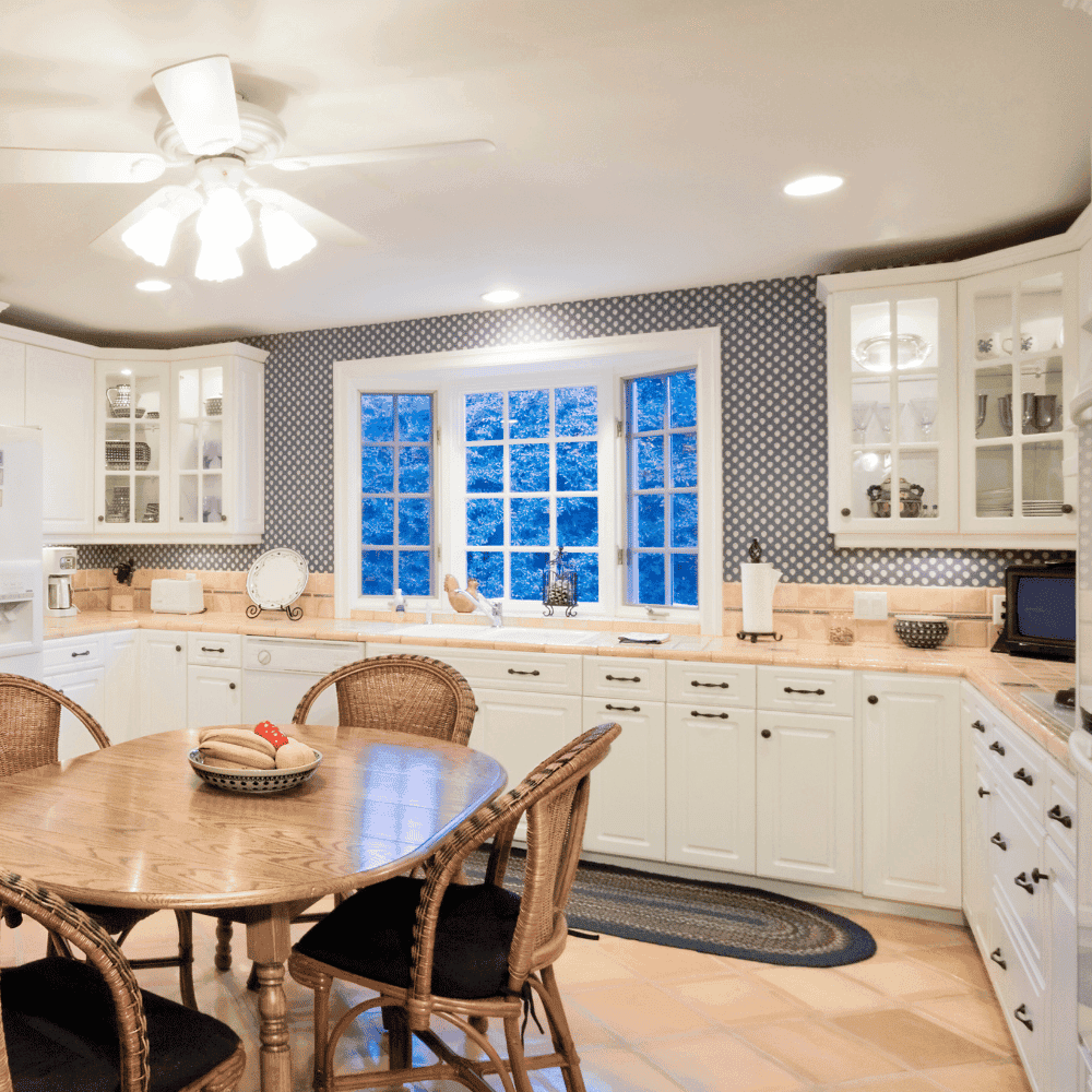 Home insurance quote Blainville home insurance blainville White kitchen with wooden table and chairs.