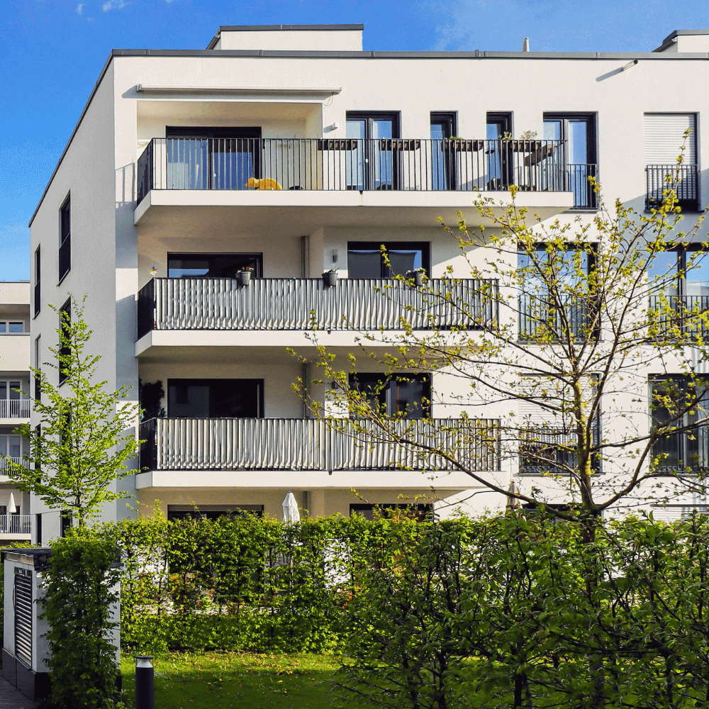 Home insurance quote Griffintown Modern building with balconies and trees.