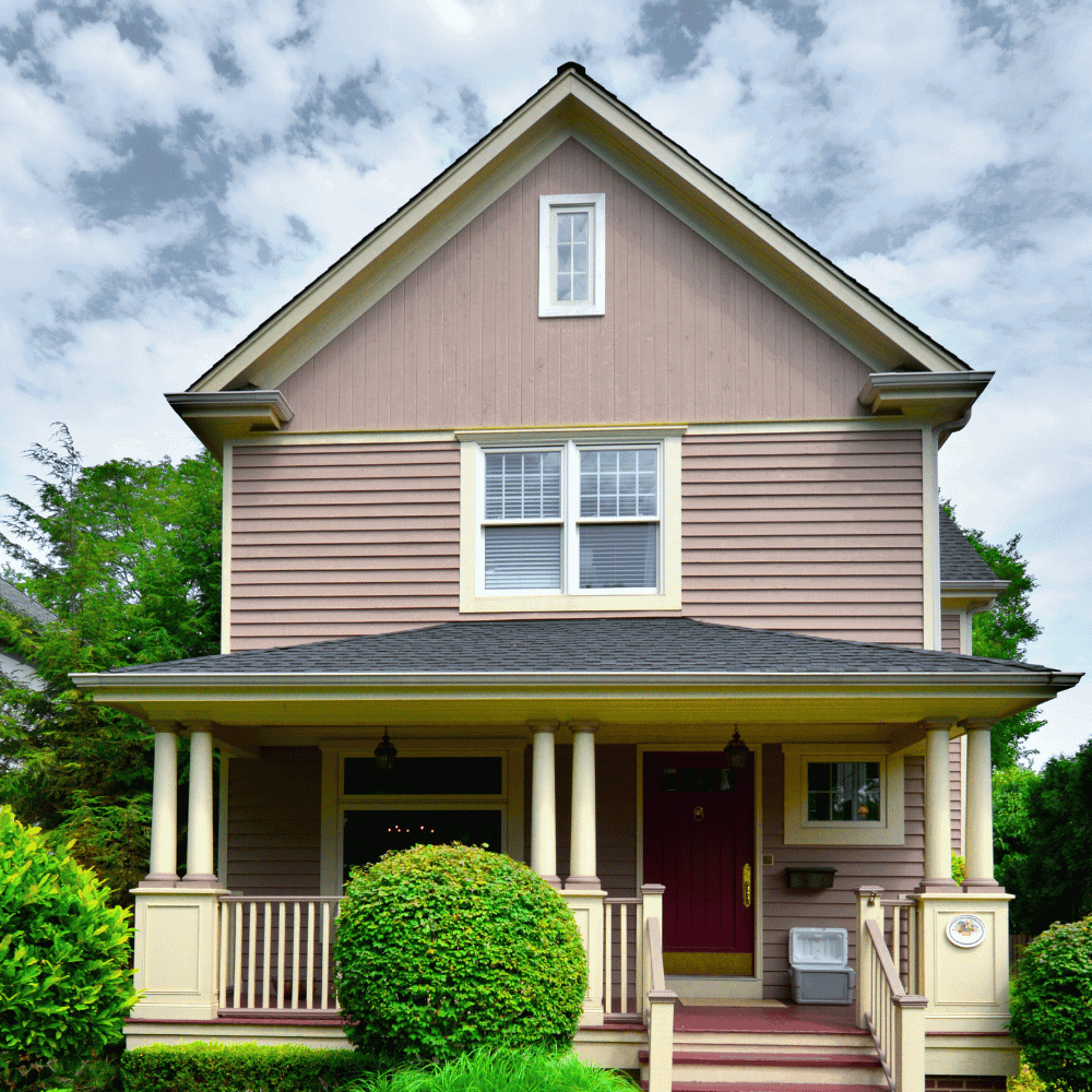 Home insurance quote Saint-Jean-sur-Richelieu Wooden house with porch, cloudy sky.