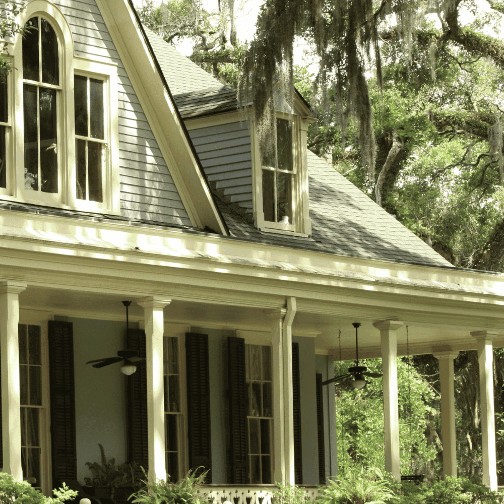 Traditional house with dormers and veranda.