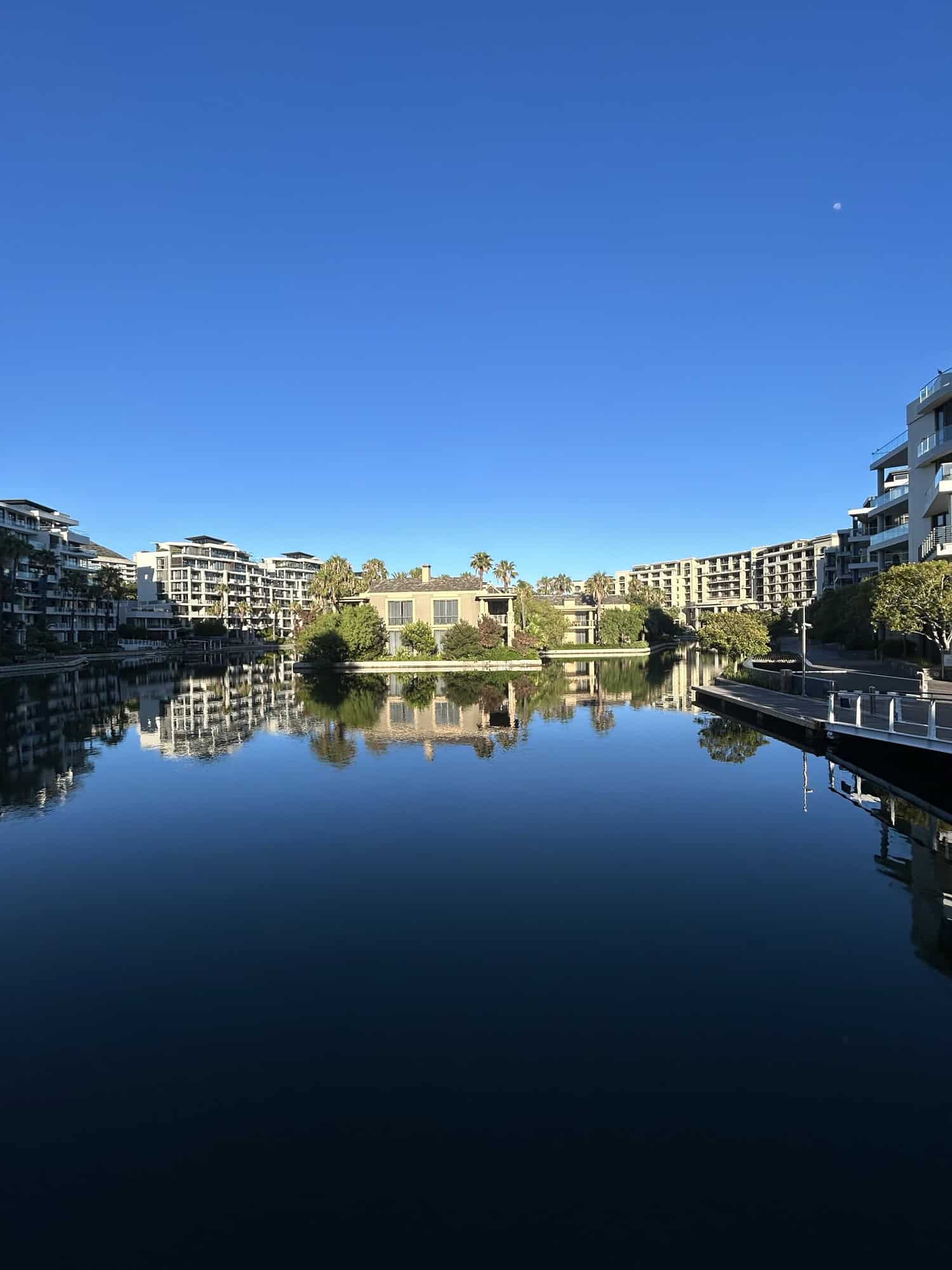The island at the One and Only Hotel at the V&A Waterfront, with the canals in the foreground.  Cape Town's spas are a must do on Cape Town girls' trip.