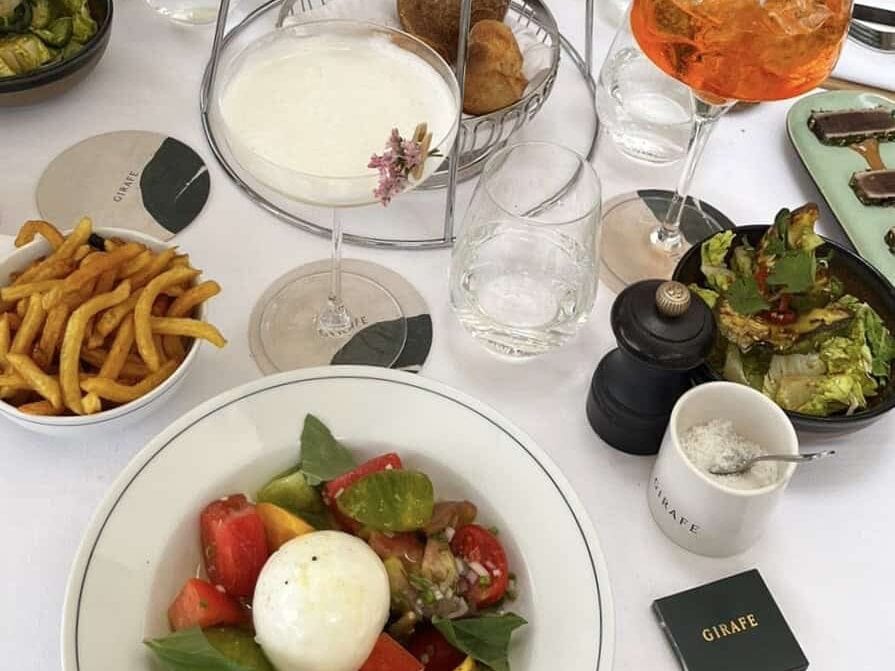 A lunch and cocktails spread at Girafe in Paris. Girafe has amazing views of the Eiffel Tower, and is perfect for a Paris girls' trip.