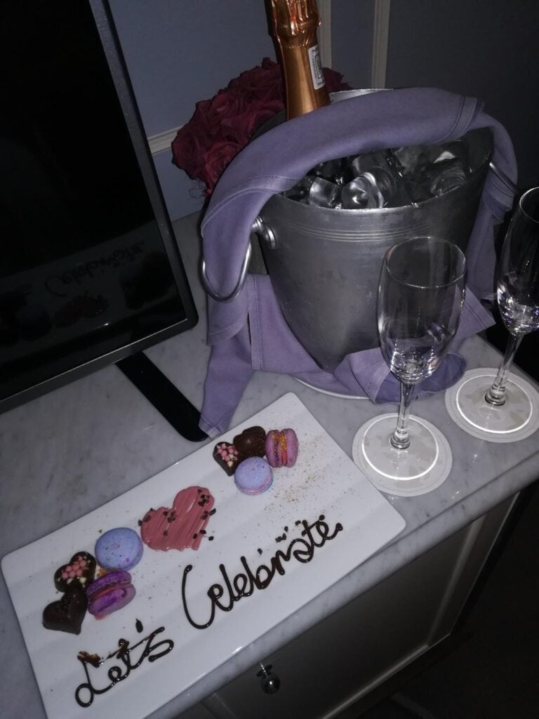 A bucket of champagne and a plate of dessert, with the words "Let's Celebrate", at the Four Seasons the Westcliff.