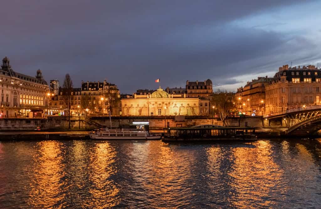 Illuminated Parisian landmarks and bridges reflecting in the Seine at night.  Photo: Kirandeep Singh Walia