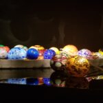 A row of colorful eggs are displayed on a table.