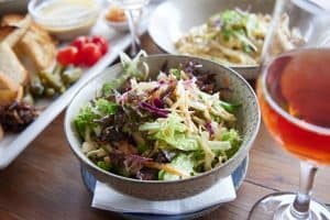 Fresh mixed salad at Bella Vita restaurant, featuring crisp greens and vibrant vegetables, ideal for healthy dining.