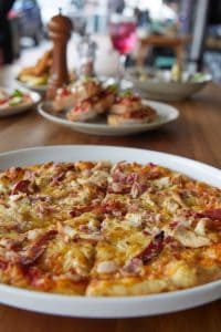 Freshly baked pizza with ham and cheese at Bella Vita restaurant in New Zealand.