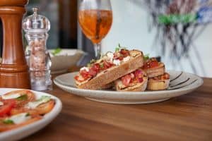 Fresh gourmet bruschetta with tomatoes, feta, and herbs on artisanal bread at Bella Vita.