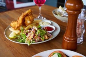 Freshly prepared fish and chips with side salad at Bella Vita restaurant in New Zealand.