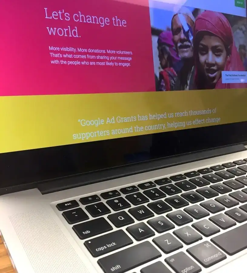Laptop screen displaying a social message about global change and community support.