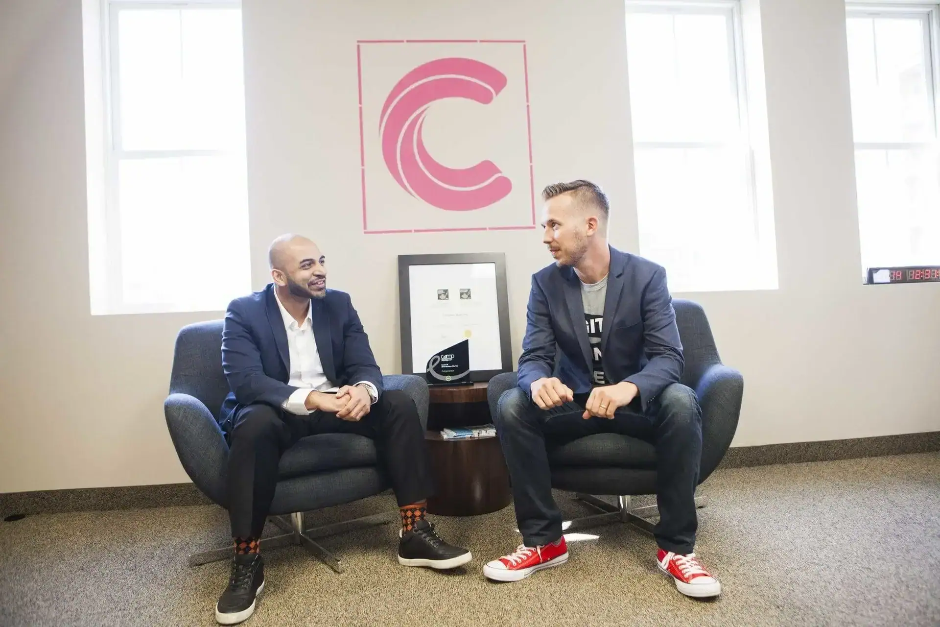 Networking meeting with two men in a modern office setting.
