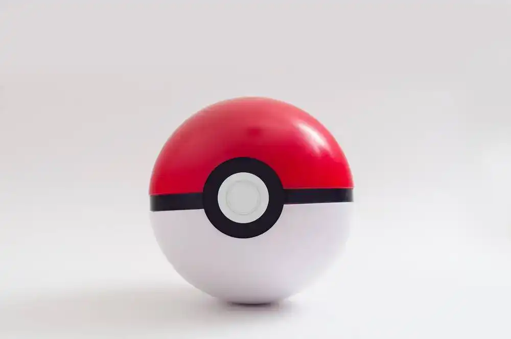 Poké Ball toy with red, white, and black design for Pokémon enthusiasts.