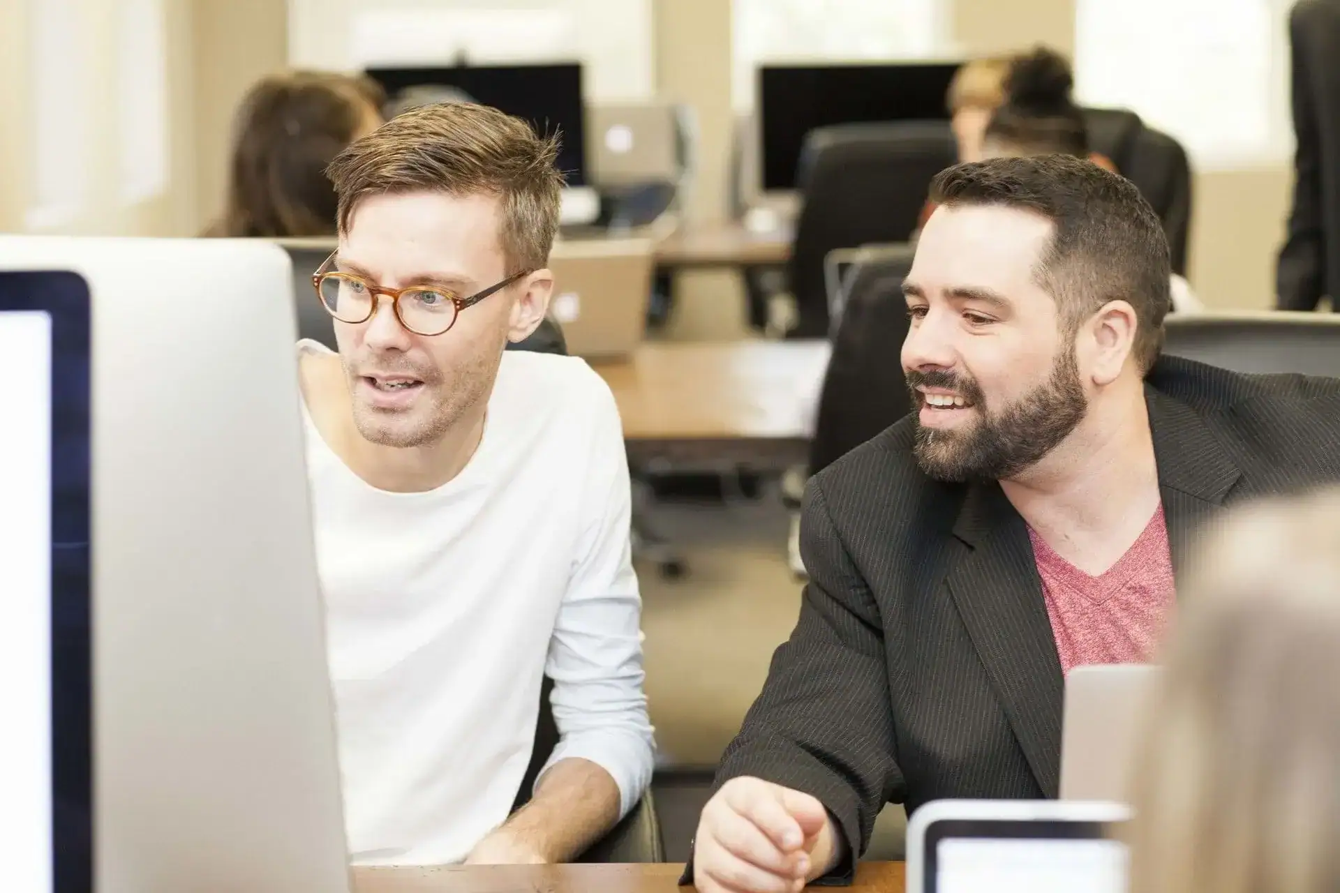 Team collaboration in a modern office setting with diverse professionals working together on compute.