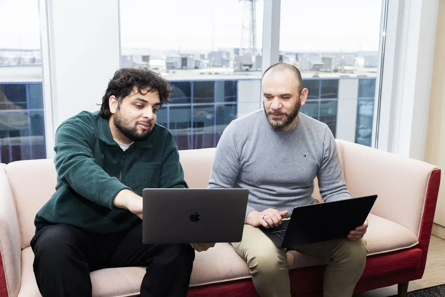 Consulting team using laptops for business services discussion.