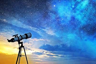 Telescopio puntato verso il cielo stellato, simbolo di ricerca tra scienza e astrologia.