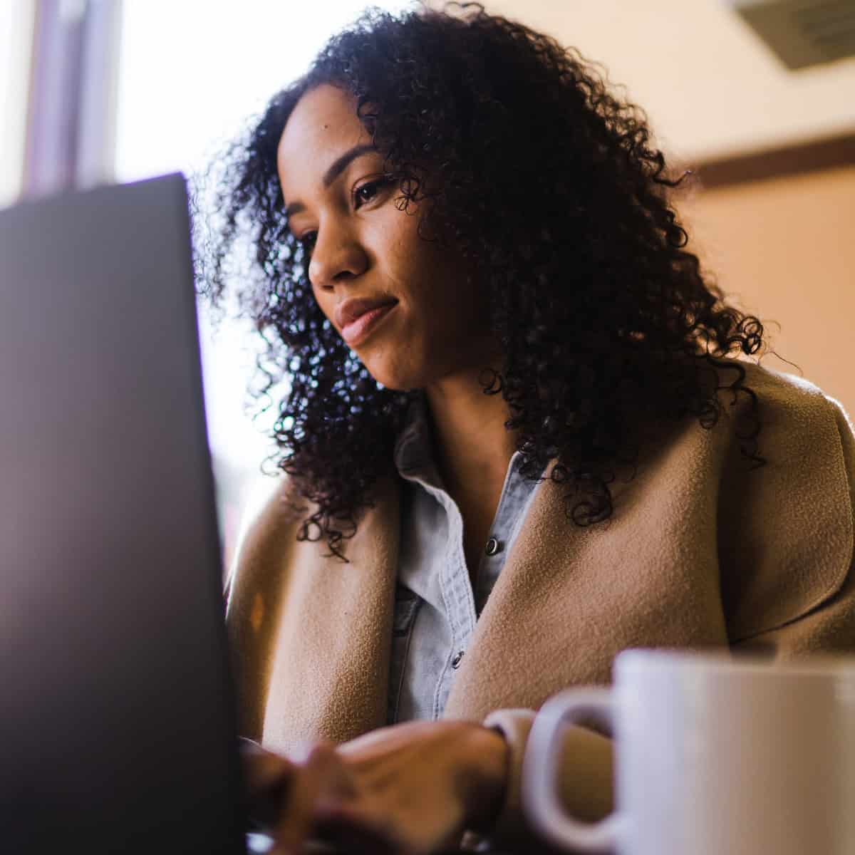 A burned-out senior professional working at her computer.
