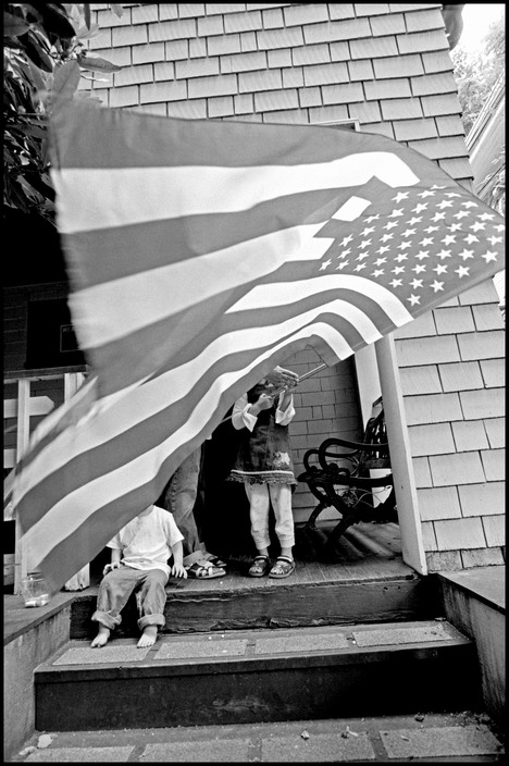 A flag unfurled in front of a porch in Portland, Ore.