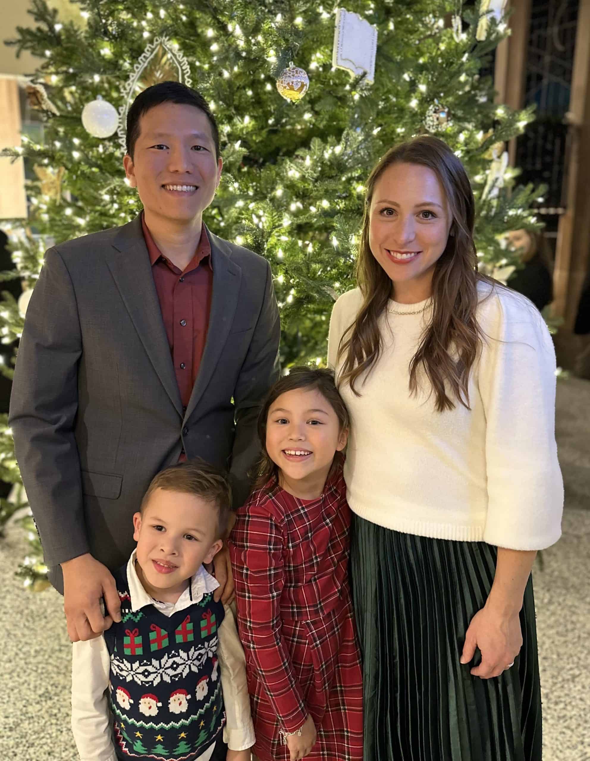 Dr. Chang Dentist Family photo Family celebrating Christmas in front of a decorated tree at Corpus Christi Family Dentistry.