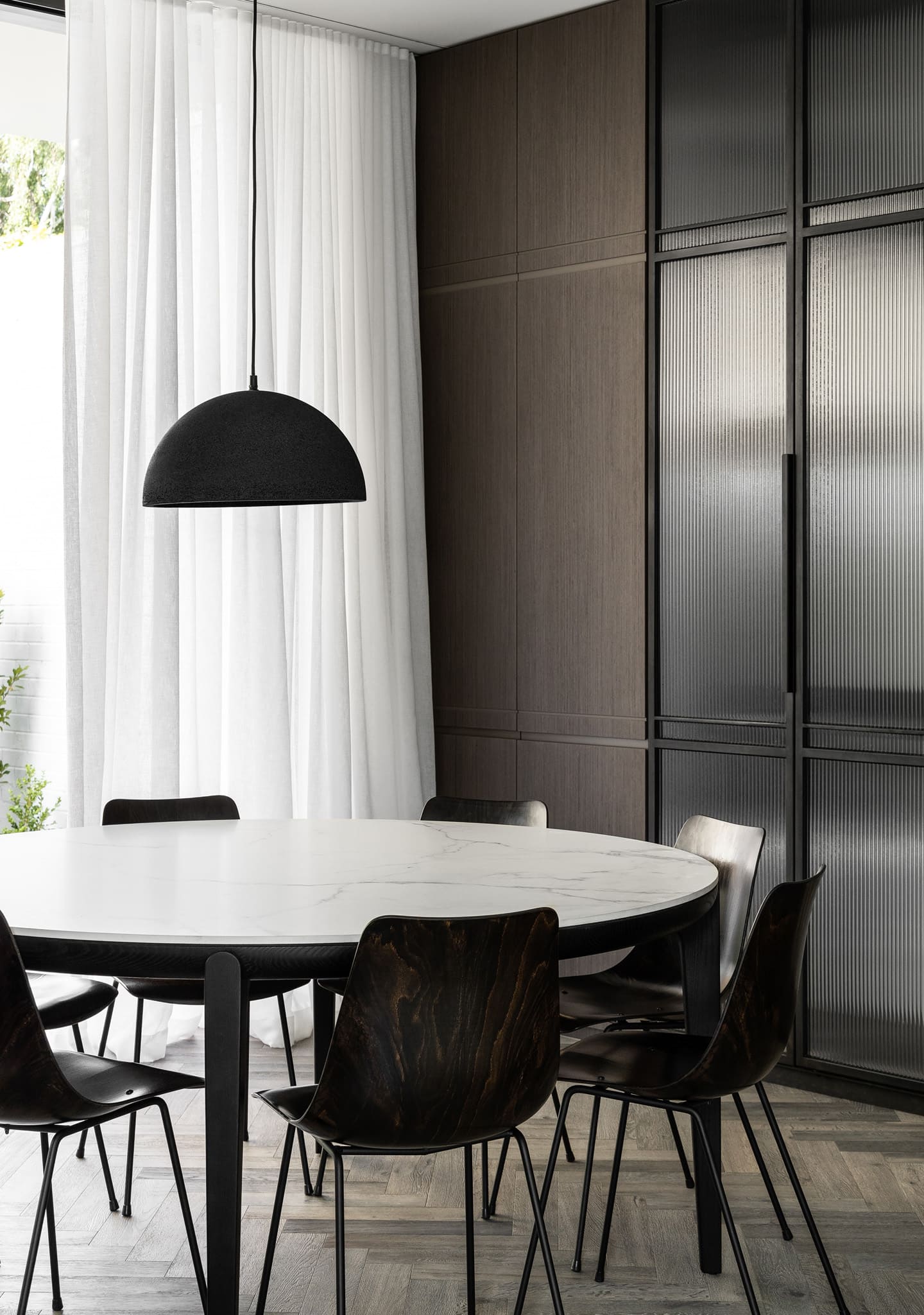 HC28 Erika Dining Table Round: Black Oak with Venetian White Top. Image Credit: Timothy Kaye X Megowan Architectural