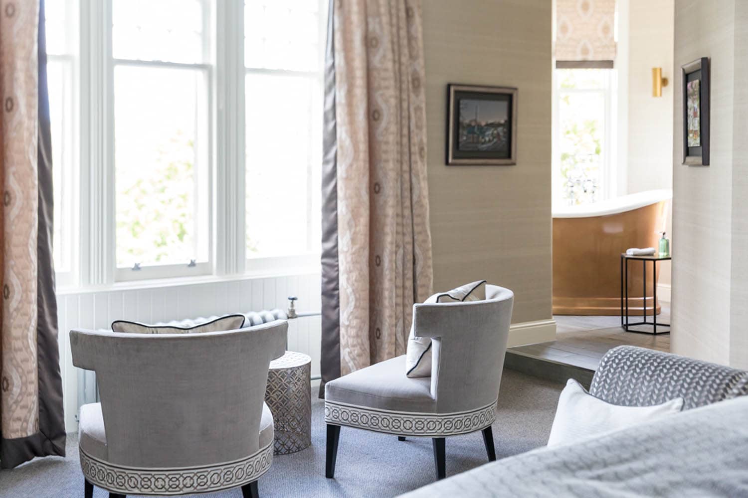 Elegant hotel room with two armchairs and large windows at The Dowans Hotel Speyside Moray.