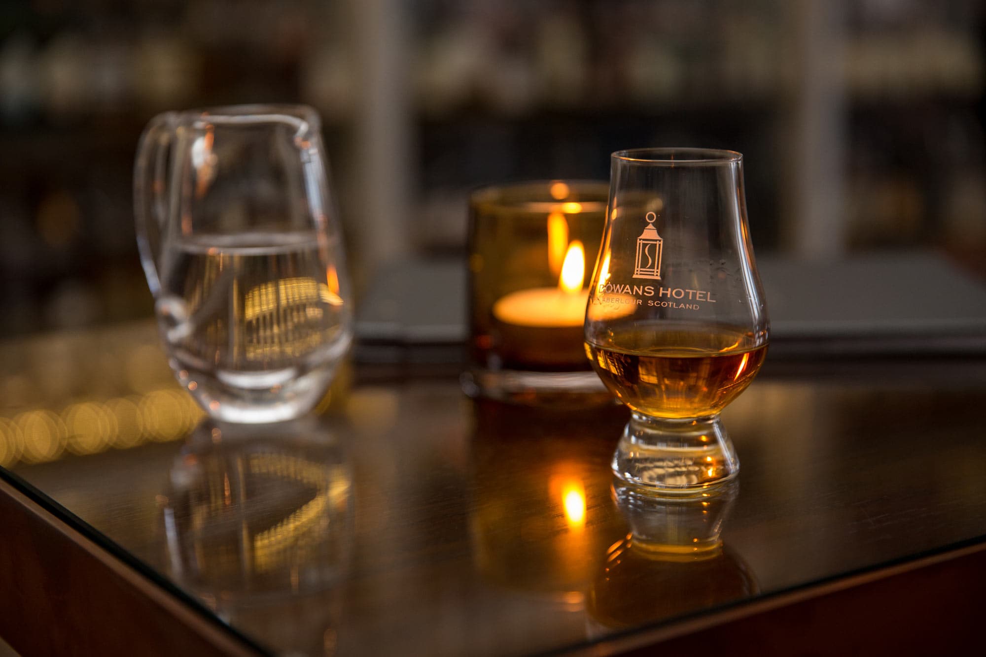 Whisky glass and candle at The Still Whisky Bar, Dowans Hotel, Moray.