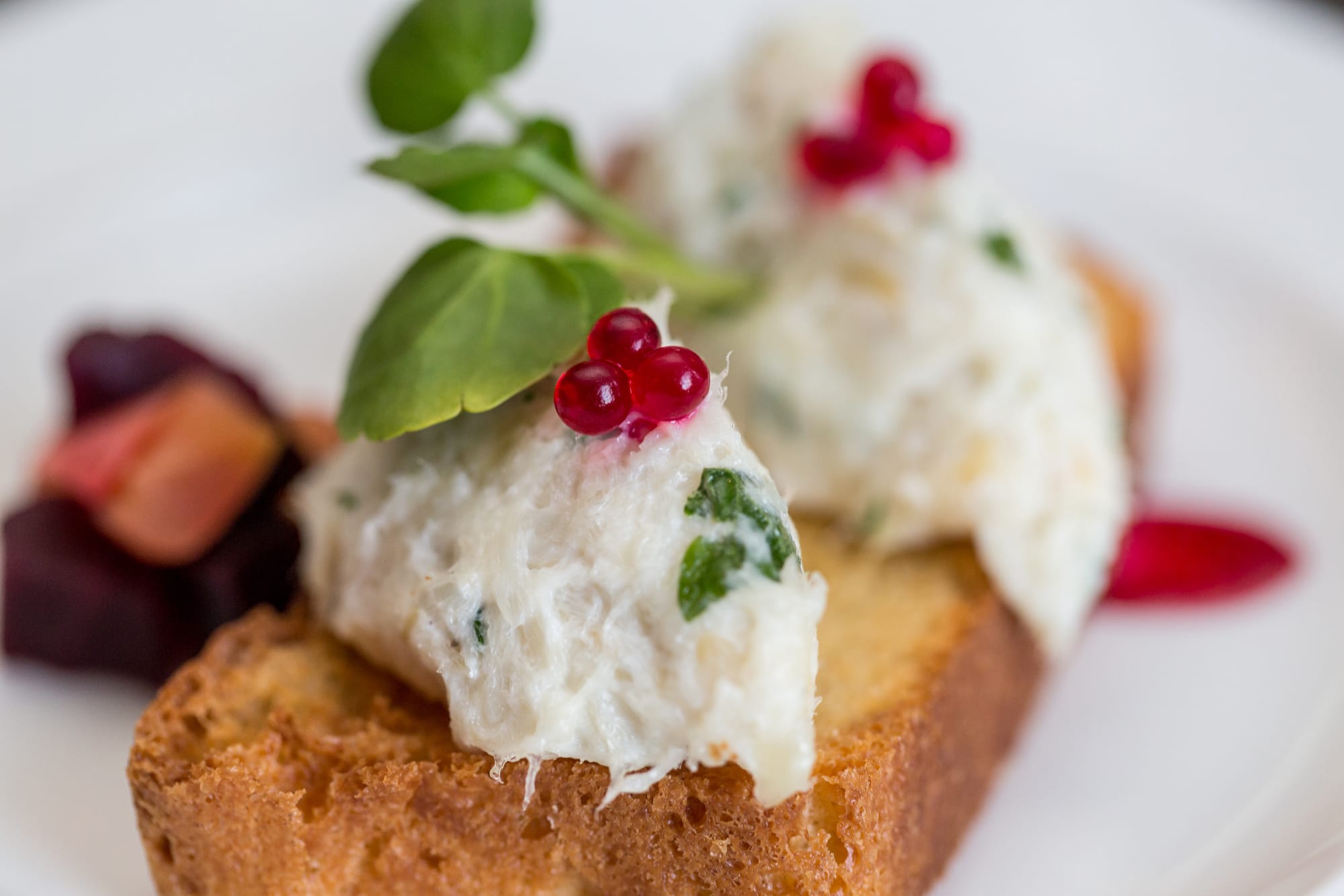 Gourmet appetizer with bread, cream, and herbs at The Dowans Hotel.