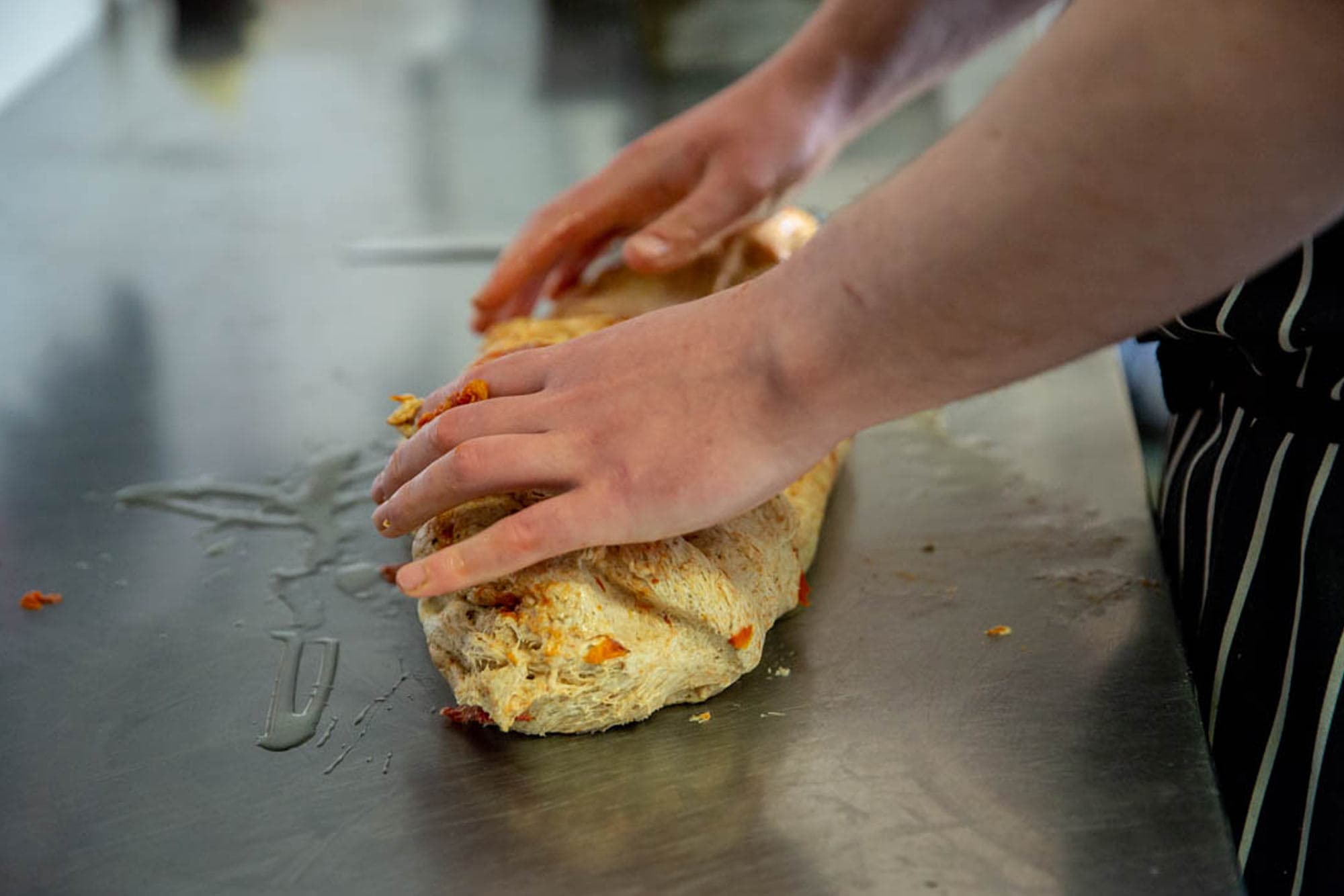 Hands preparing a Scotch pie with meat filling at Dowans Hotel, Speyside Moray.